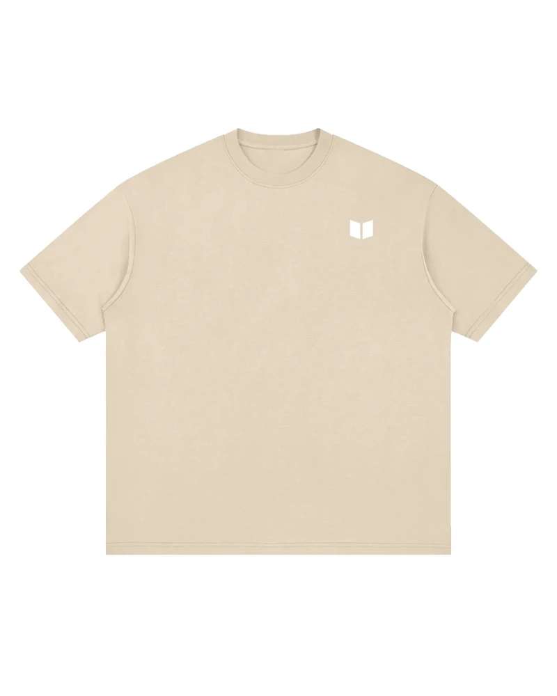 A mockup of the RAIN drop-shoulder t-shirt in grey apricot, from the front: The Transformation Edge mark, small and white, on the chest.