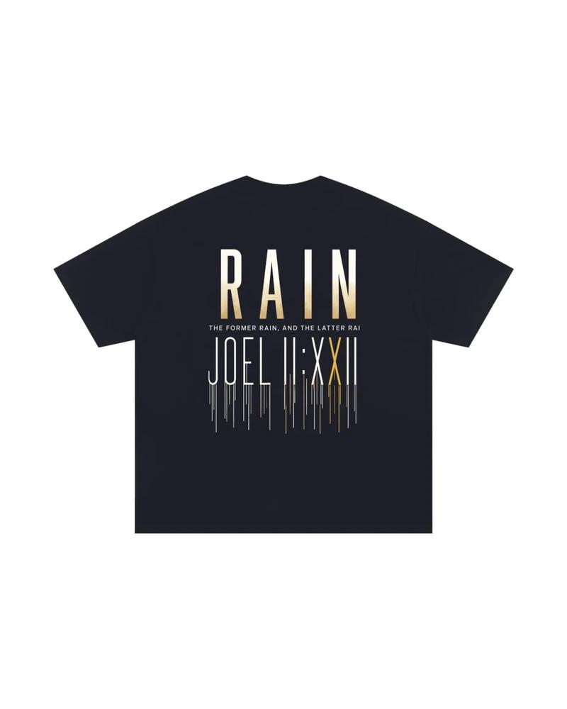 A mockup of the RAIN essential t-shirt in navy, from the back: RAIN in tall letters shading from white to gold, the words “The former rain, and the latter rain”, and Joel 2:23 in Roman numerals beneath, its strokes running down like rain.