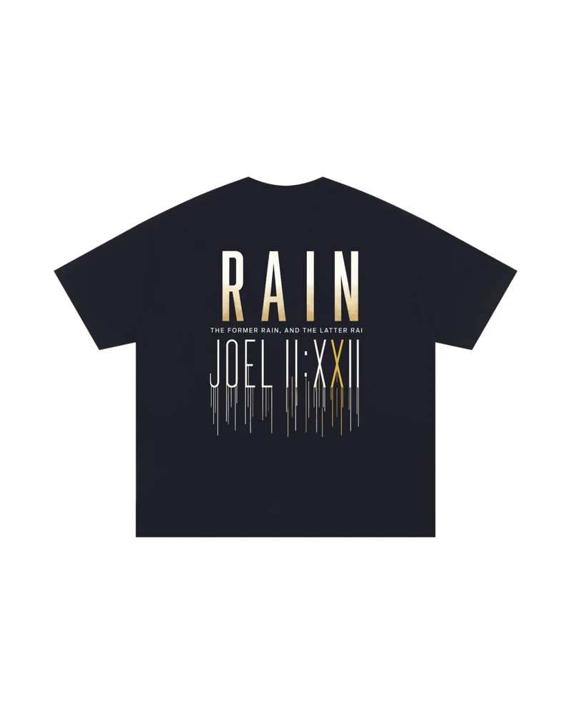A mockup of the RAIN essential t-shirt in navy, from the back: RAIN in tall letters shading from white to gold, the words “The former rain, and the latter rain”, and Joel 2:23 in Roman numerals beneath, its strokes running down like rain.