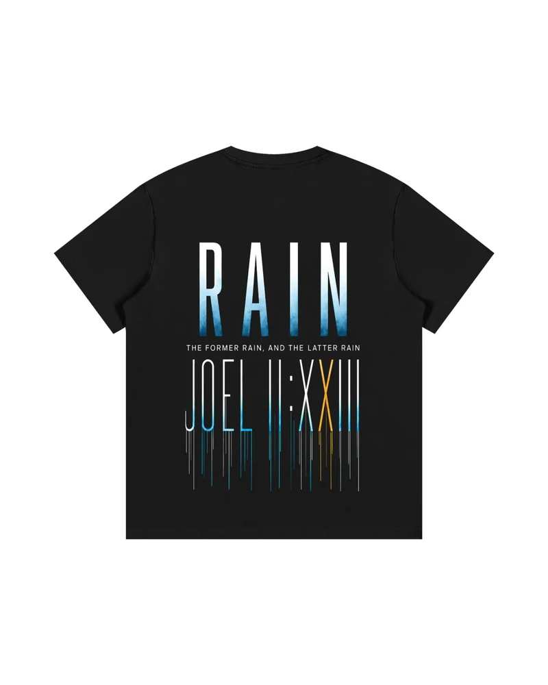 A mockup of the RAIN oversized t-shirt in black, from the back: RAIN in tall letters shading from white to blue, the words “The former rain, and the latter rain”, and Joel 2:23 in Roman numerals beneath, its strokes running down like rain.