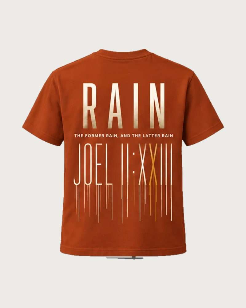 A mockup of the RAIN t-shirt in rust, from the back: RAIN in tall cream letters, the words “The former rain, and the latter rain”, and Joel 2:23 in Roman numerals running down like rain.